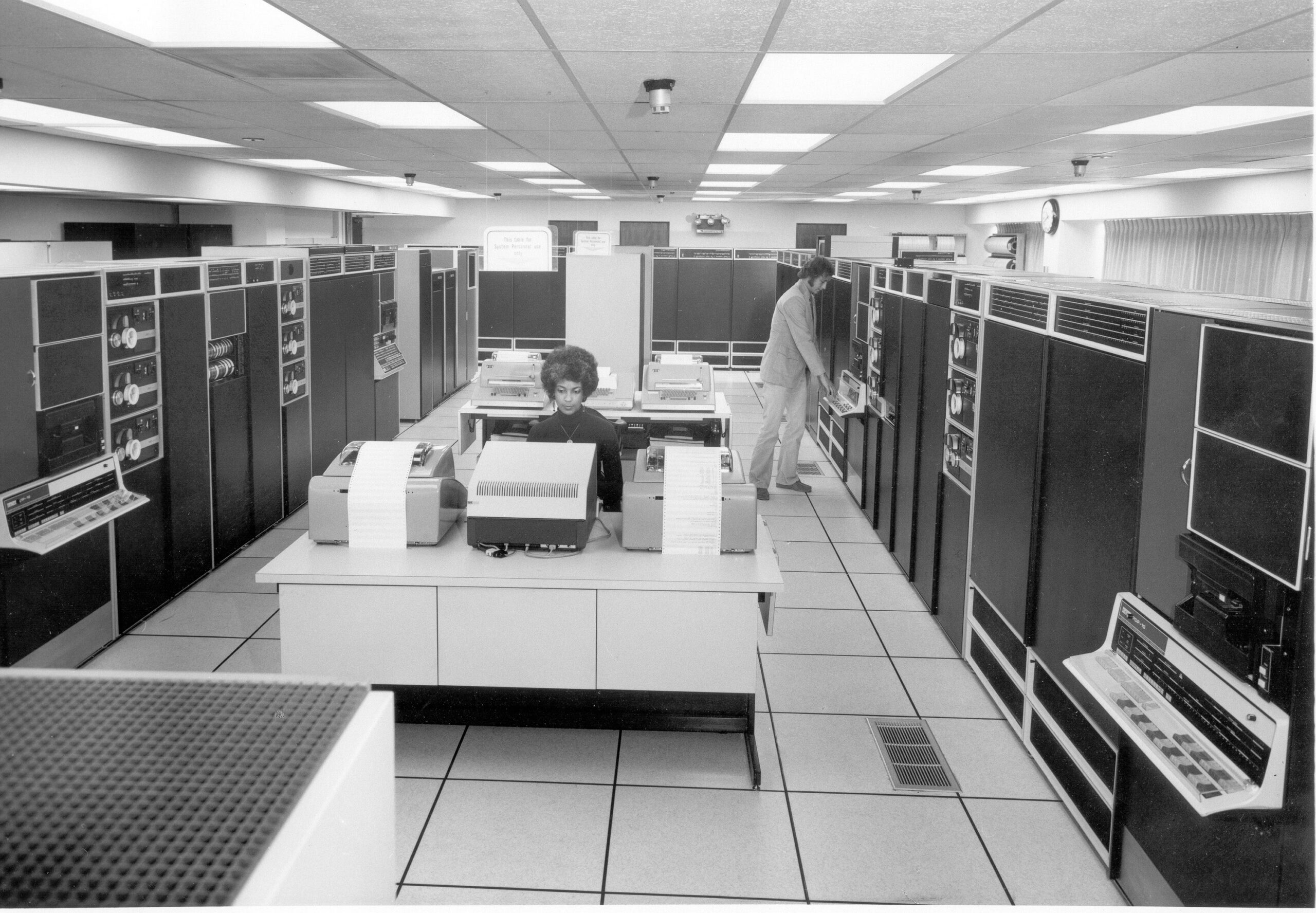 Black and white photo of mainframe computers in a room
